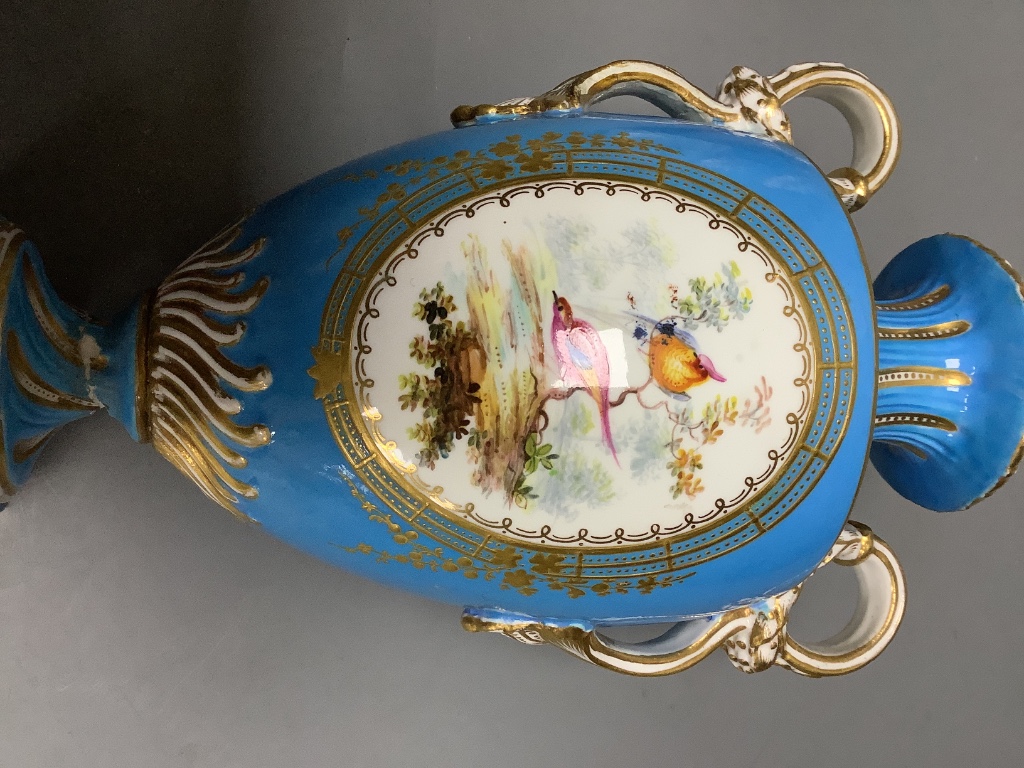 A pair of mid 19th century Coalport turquoise ground two handled vases, painted in Sévres style with birds in gilt panels 20.5cm